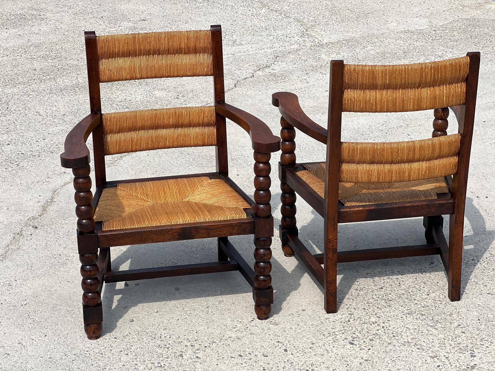Pair of stained oak and straw armchairs, French work, 1950