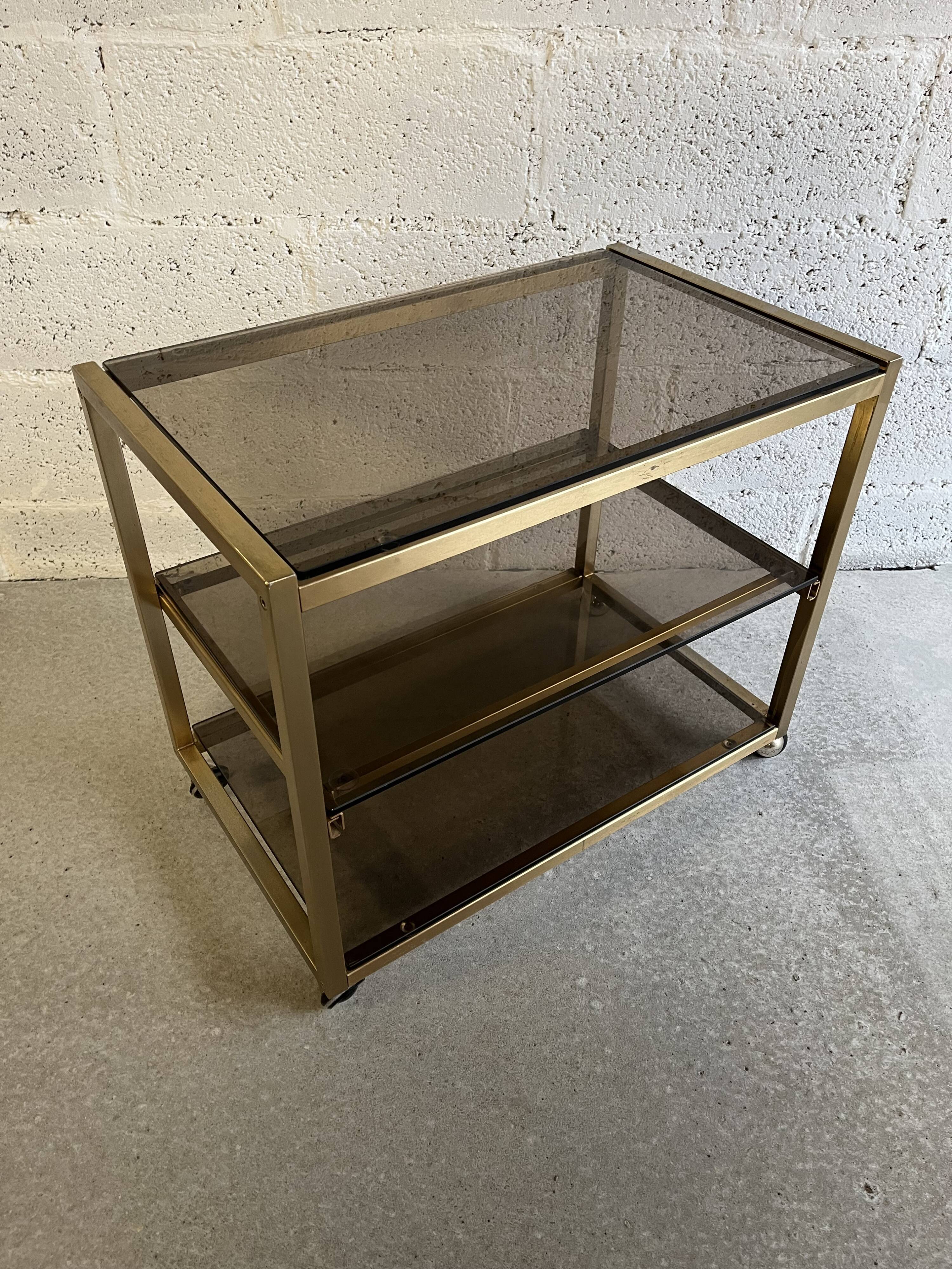 Gold metal and smoked glass serving trolley from the 70s