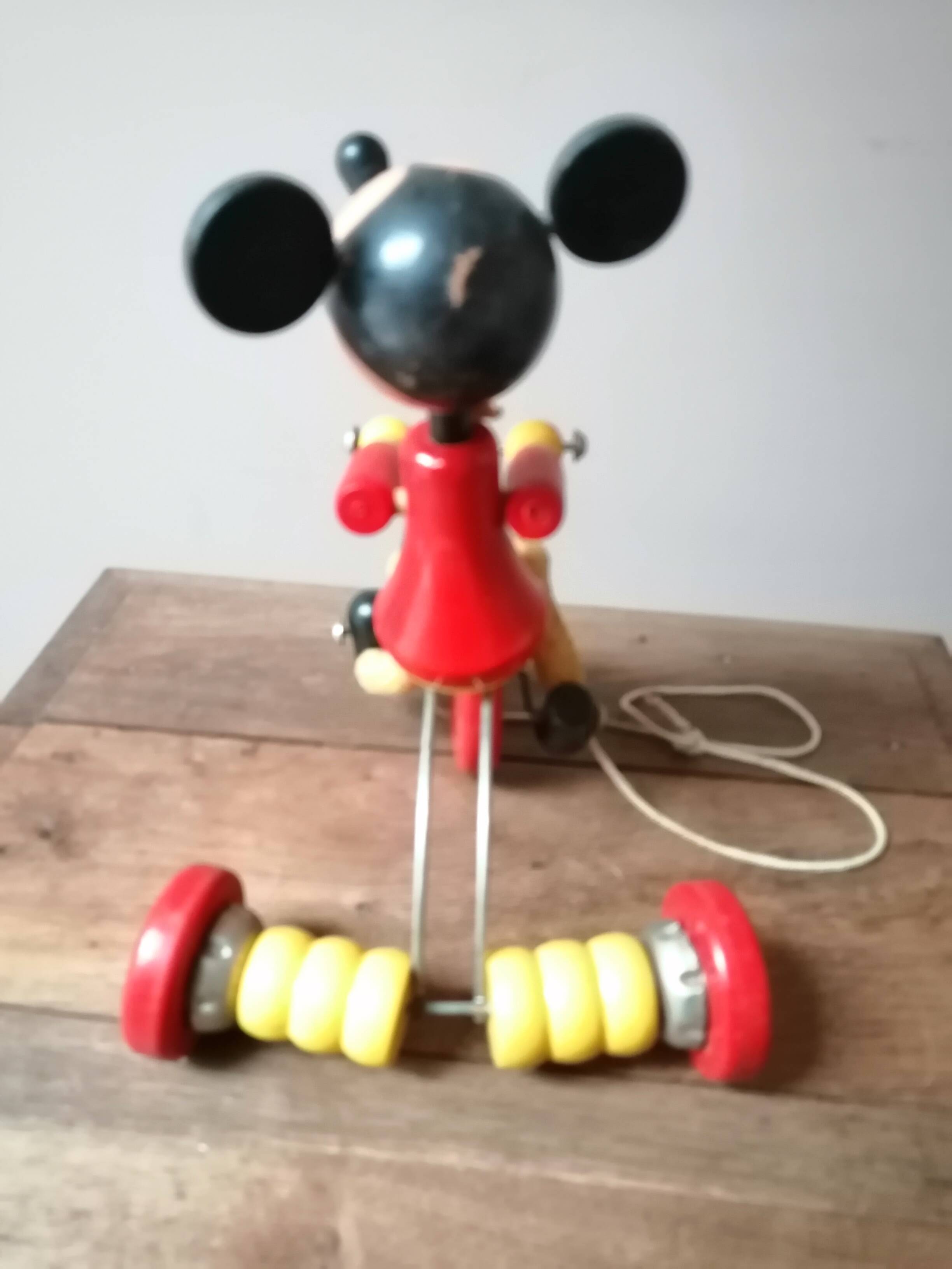 Old Mickey Mouse toy on his wooden tricycle
