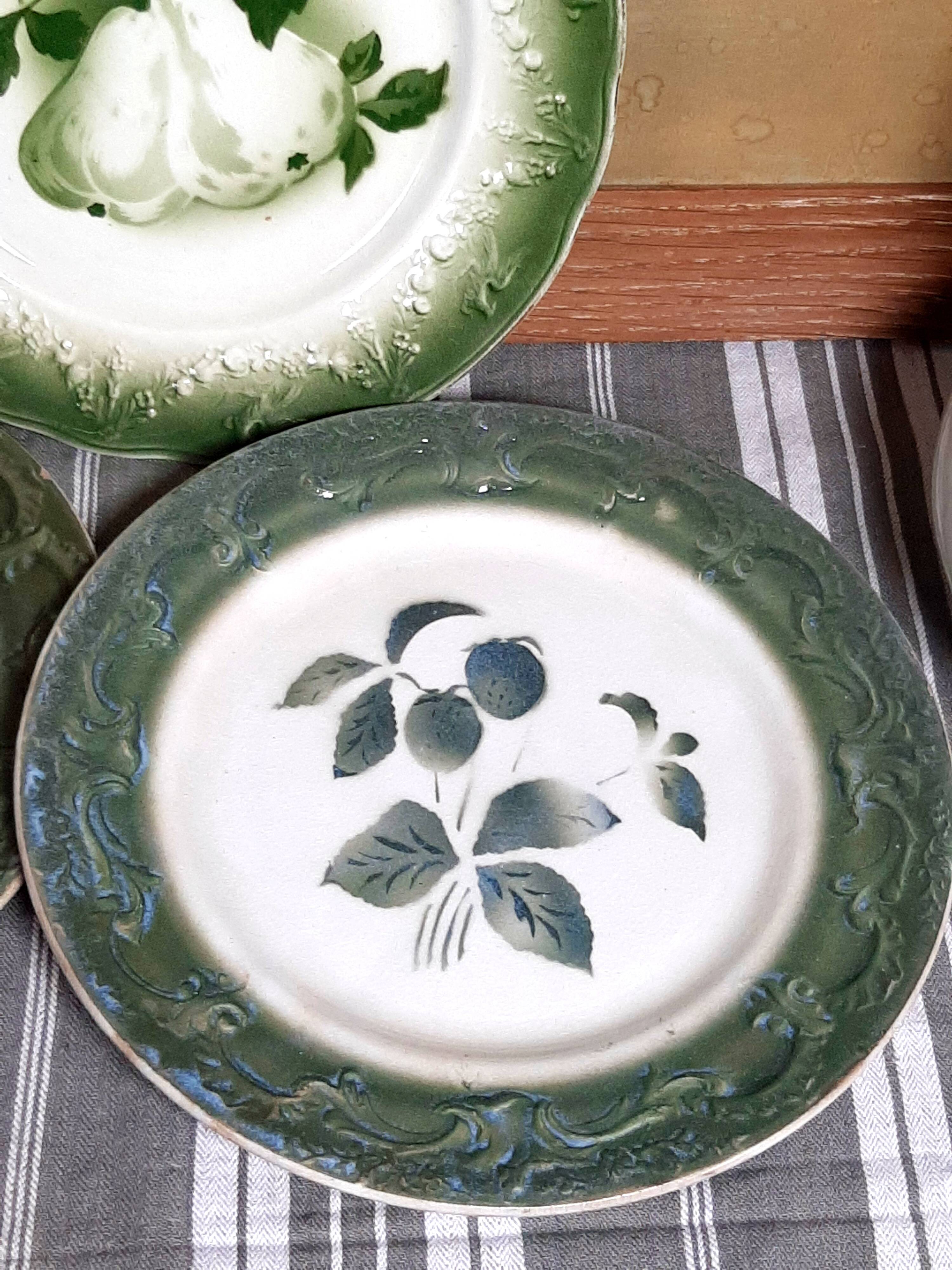 Antique earthenware plates with fruit decoration.