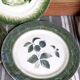 Antique earthenware plates with fruit decoration.