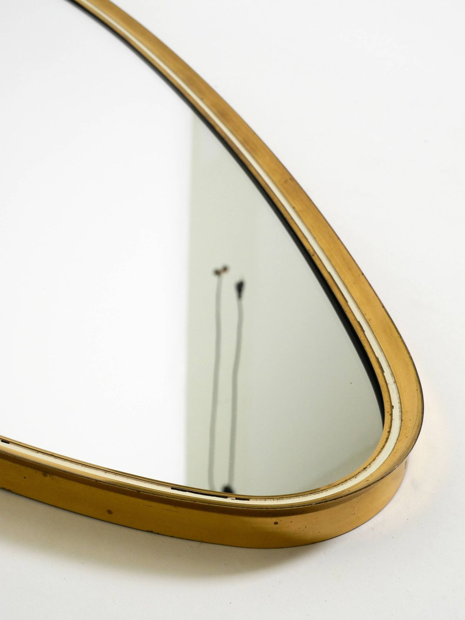 Heavy mid-century brass kidney-shaped wall mirror from Münchner Zierspiegel