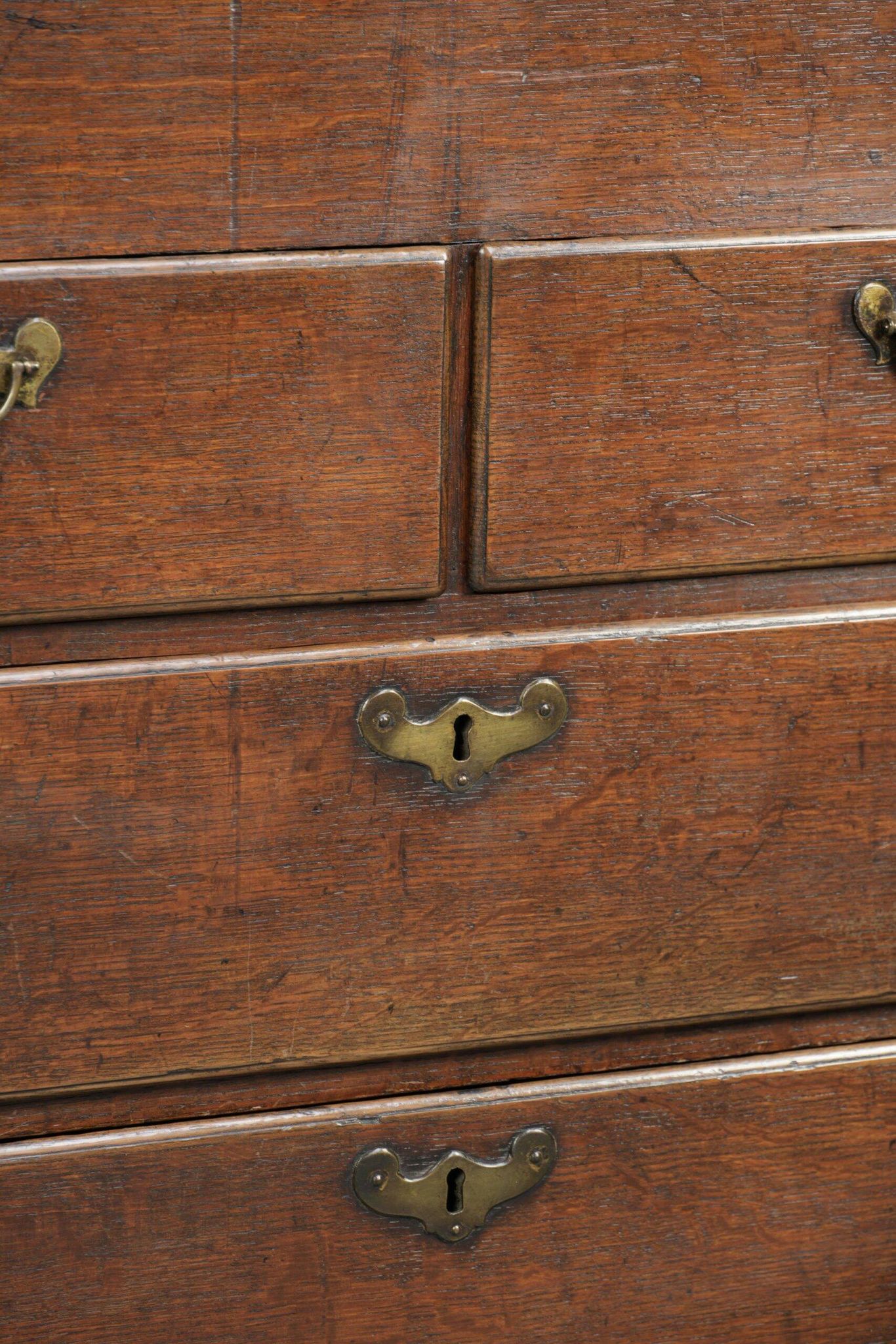 Antique English oak secretary from the 18th century with a stepped interior
