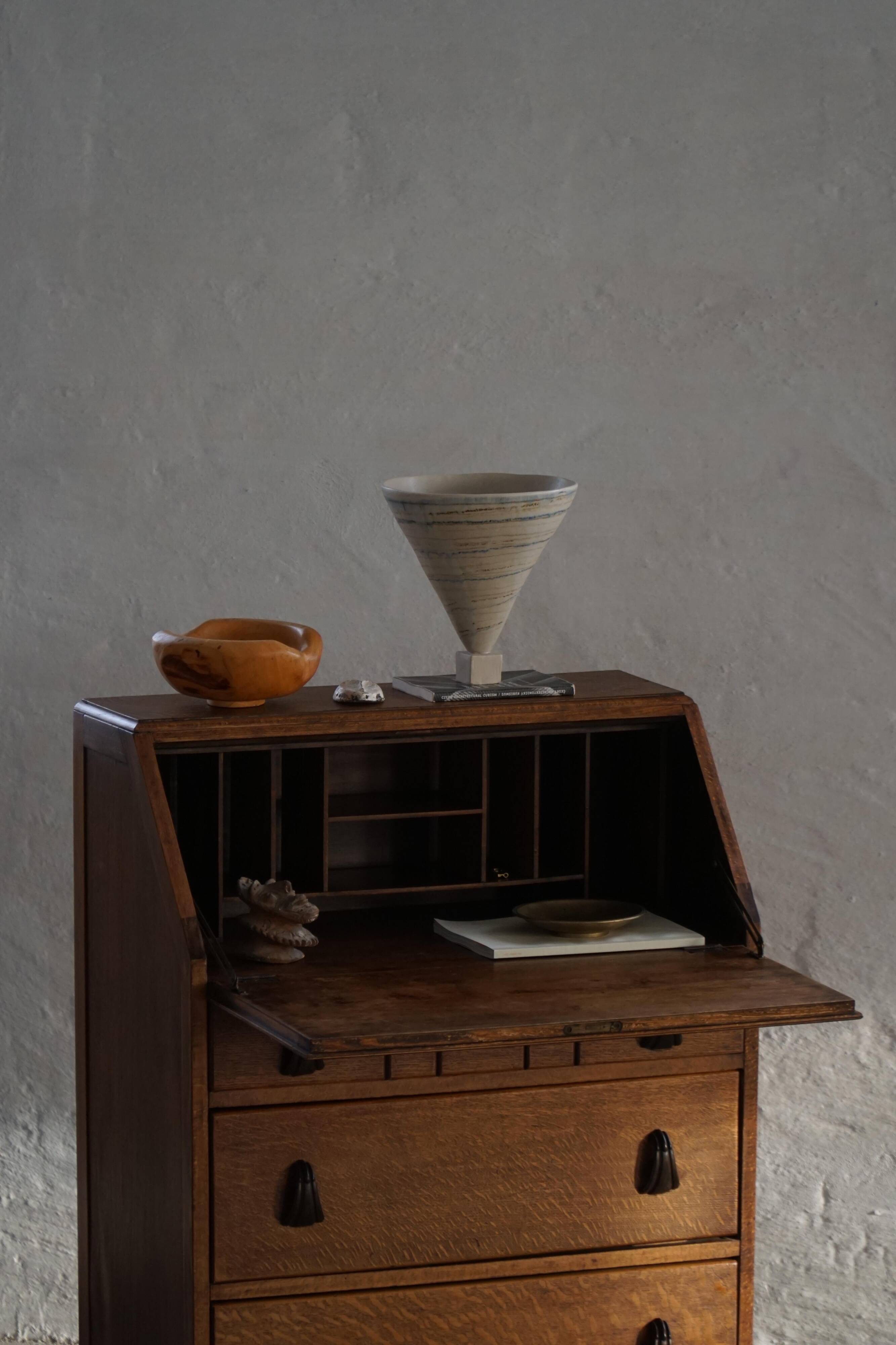 Desk / Chest of drawers in modern Danish oak from the early 20th century with shell handles.