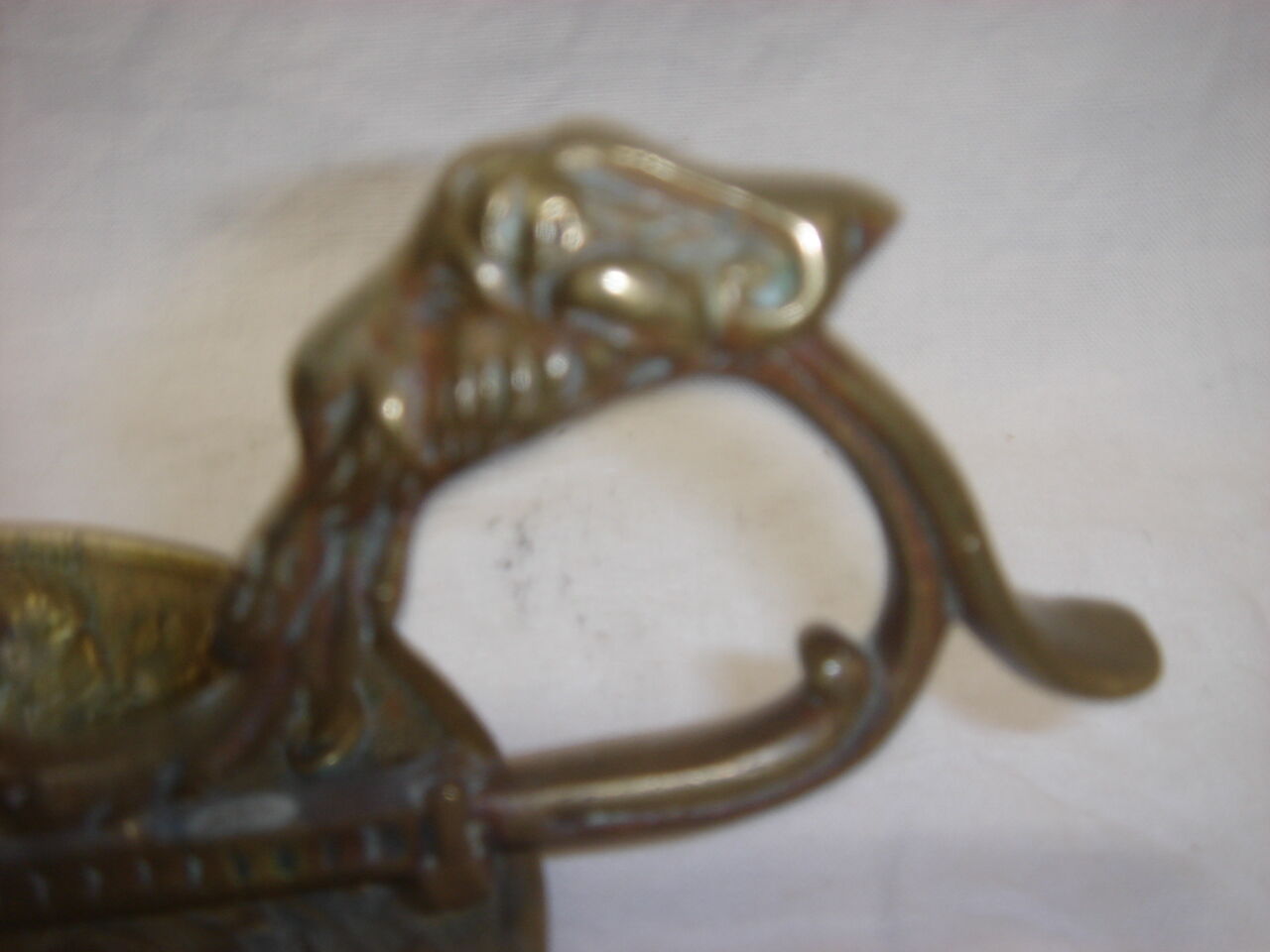 Ancient candlestick in carved bronze ram