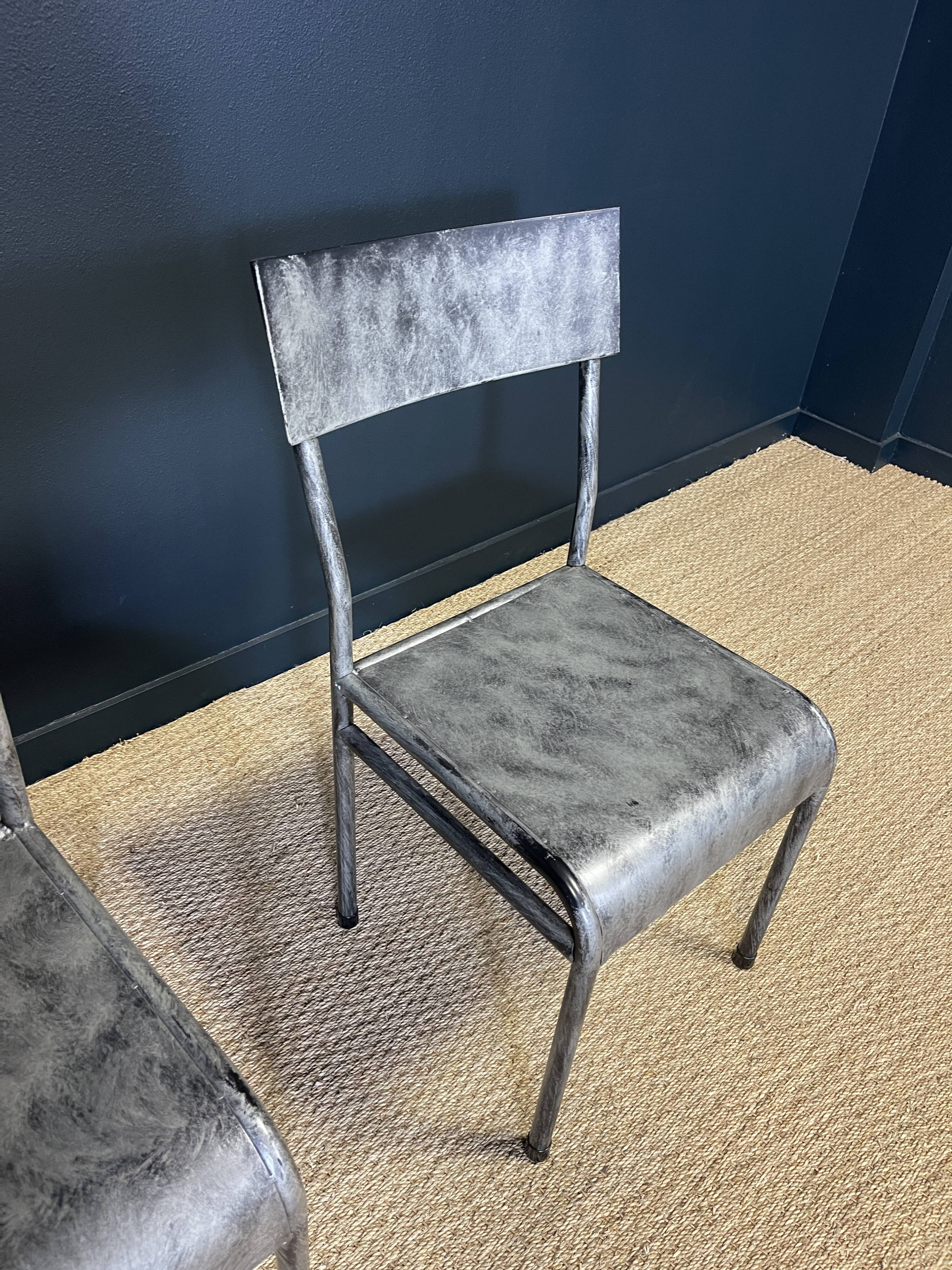 Pair of gray metal industrial chairs
