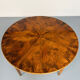 Round walnut Napoleon III extendable table with bronze top in good condition.