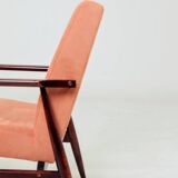 Mid-century modern armchair in coral red designed by H. Lis.