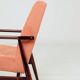 Mid-century modern armchair in coral red designed by H. Lis.