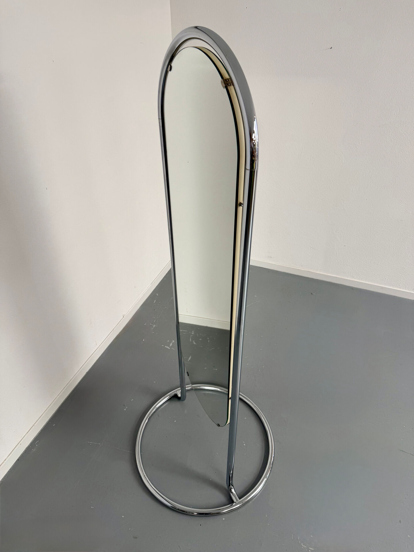 Large freestanding chrome metal full-length mirror in 1970s design.