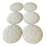 White saucer with raised inlaid pattern