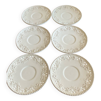 White saucer with raised inlaid pattern