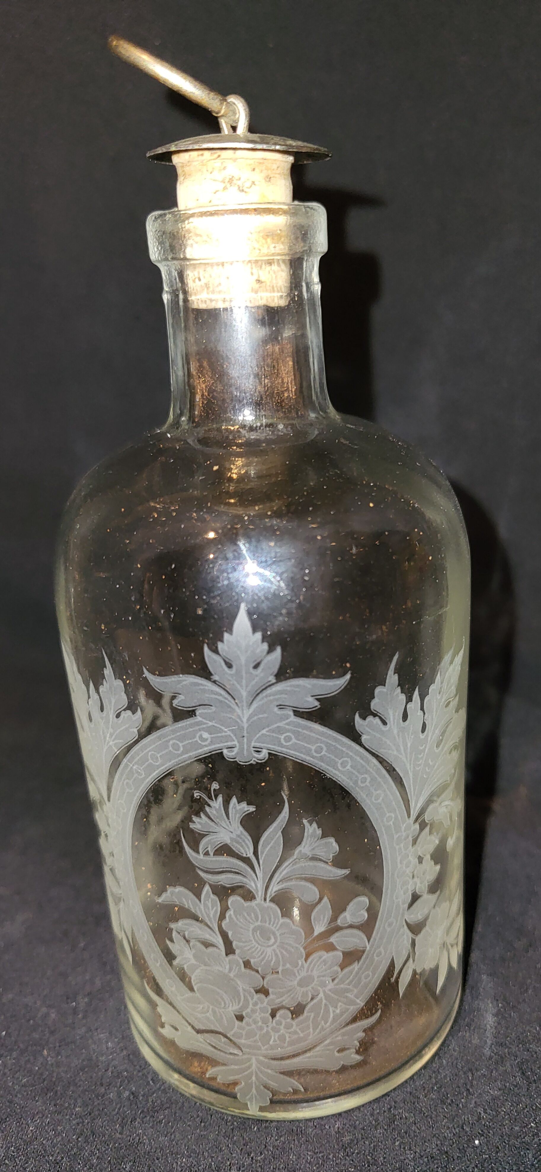 Engraved glass bottle