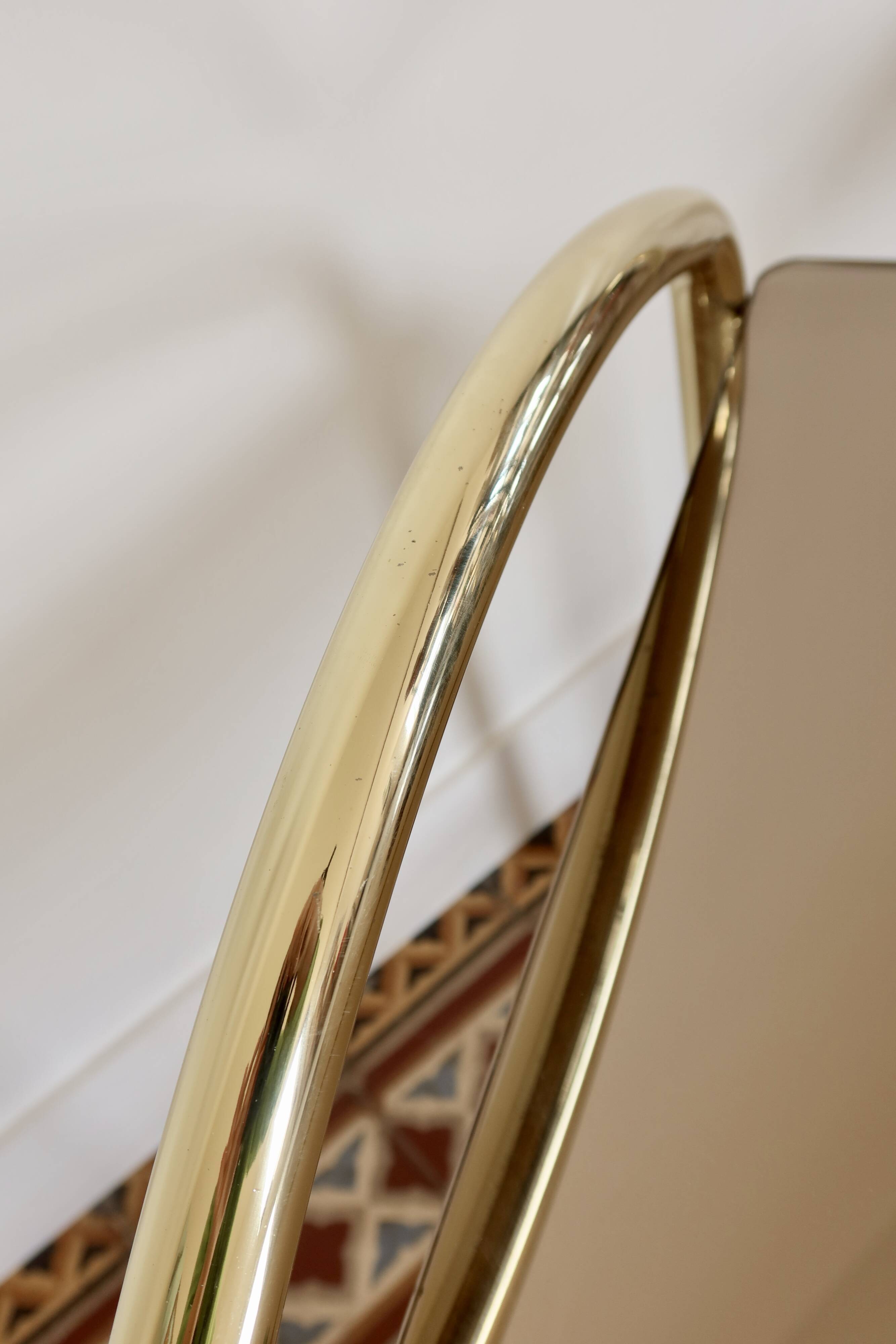 Pair of bedside tables with gold metal and mirrored glass top.