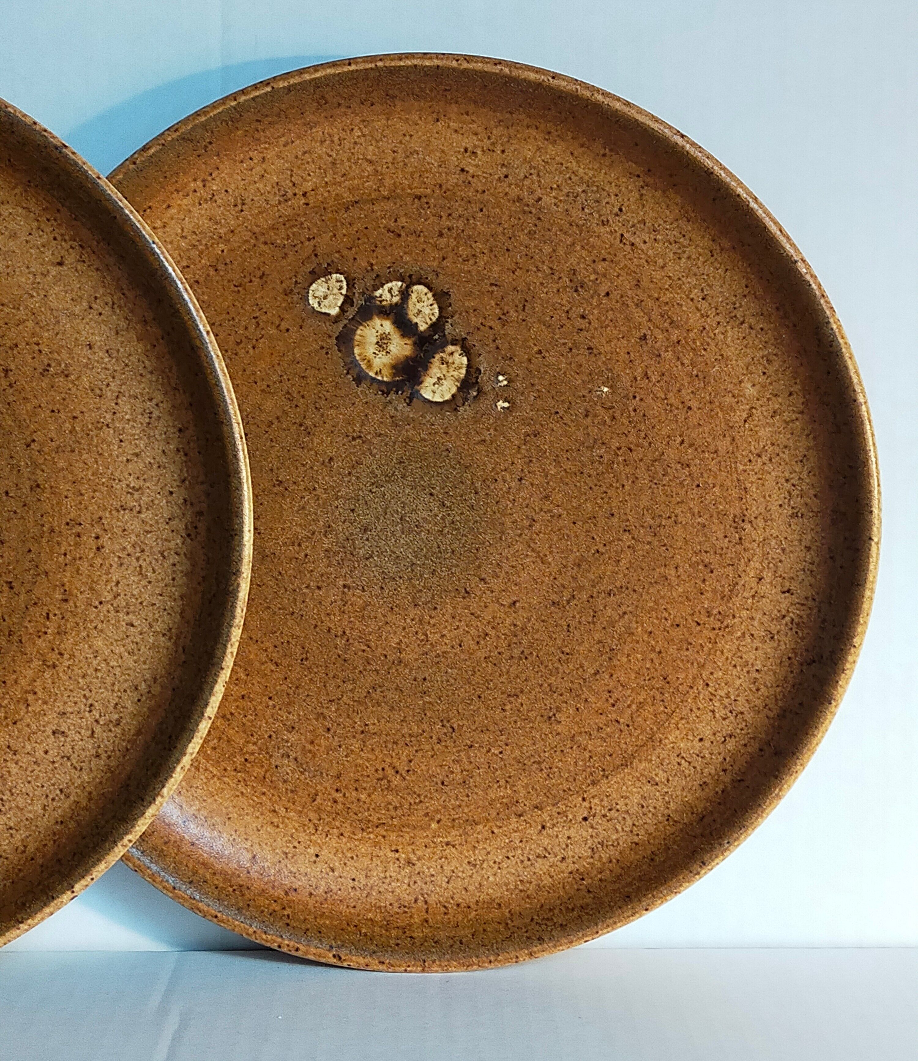 Four vintage glazed stoneware potter's plates