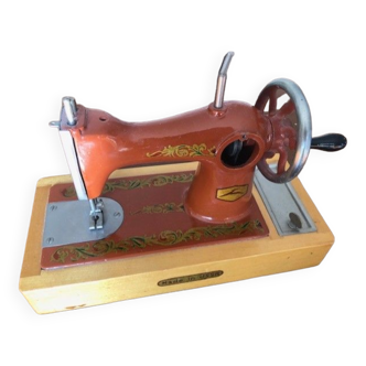 Mini Soviet metal sewing machine on wooden stand