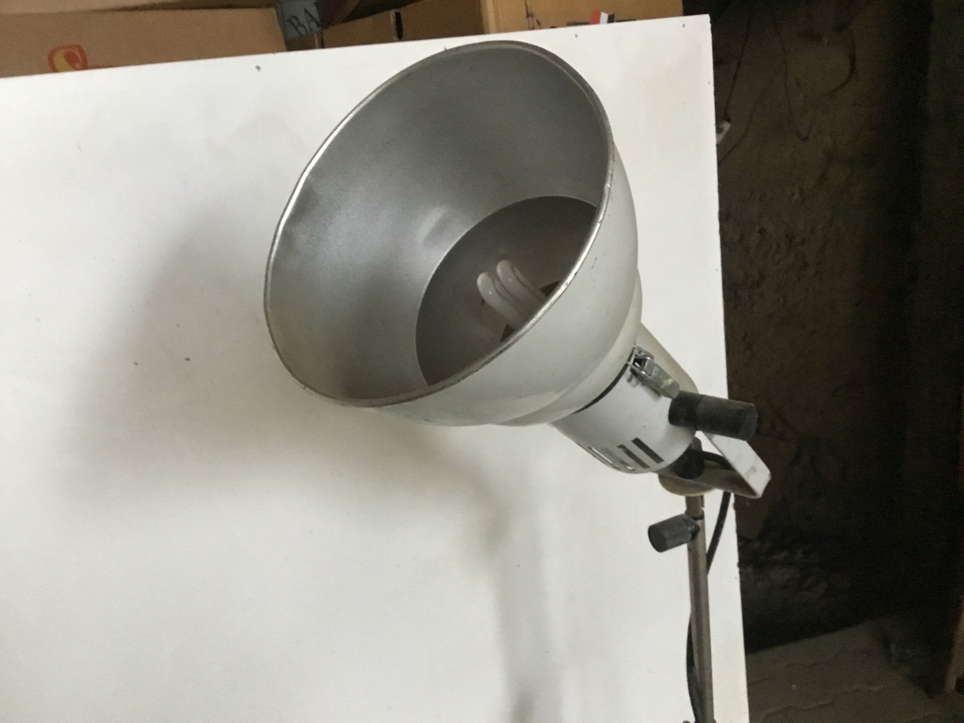 Industrial lamp on wrought iron tripod feet