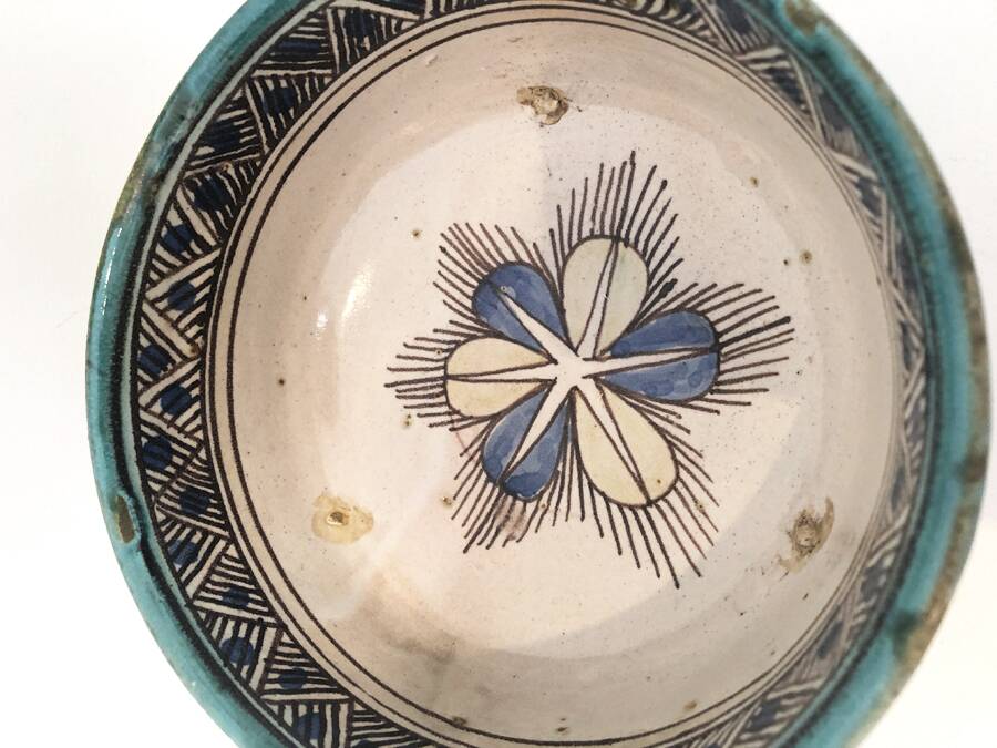 Cup on a ceramic pedestal – blue and turquoise geometric design.