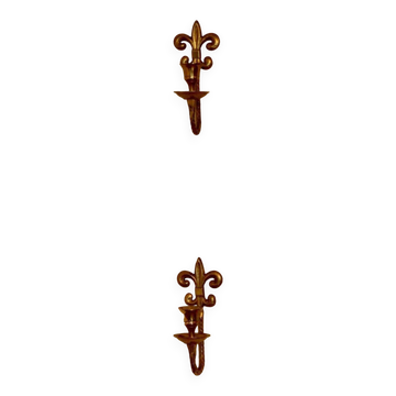A pair of antique brass wall sconces.