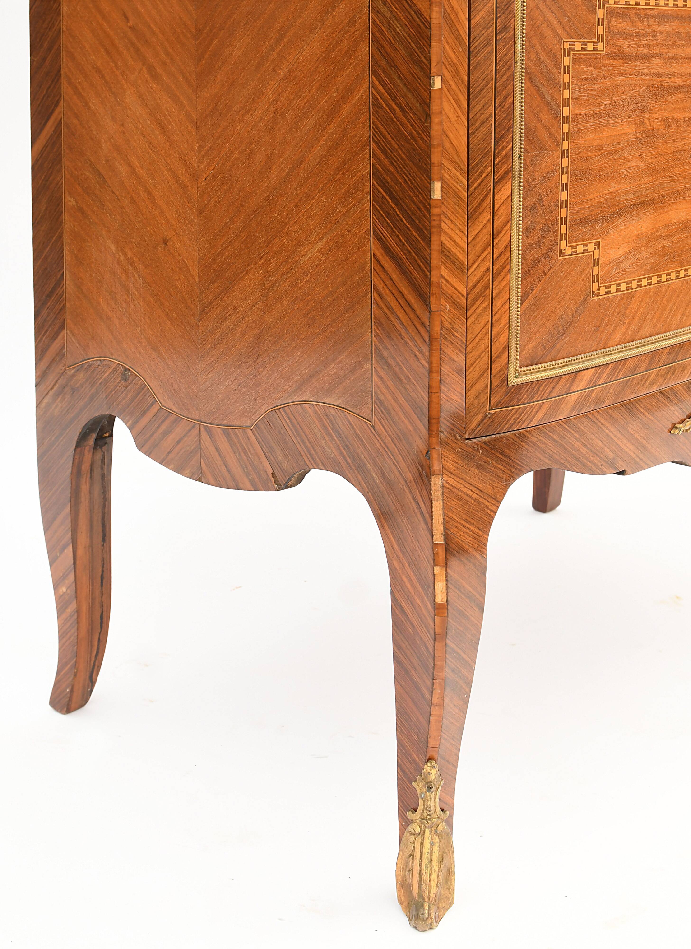 In-between furniture in marquetry decorated with a trophy decoration of musical instruments