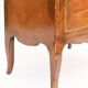 In-between furniture in marquetry decorated with a trophy decoration of musical instruments