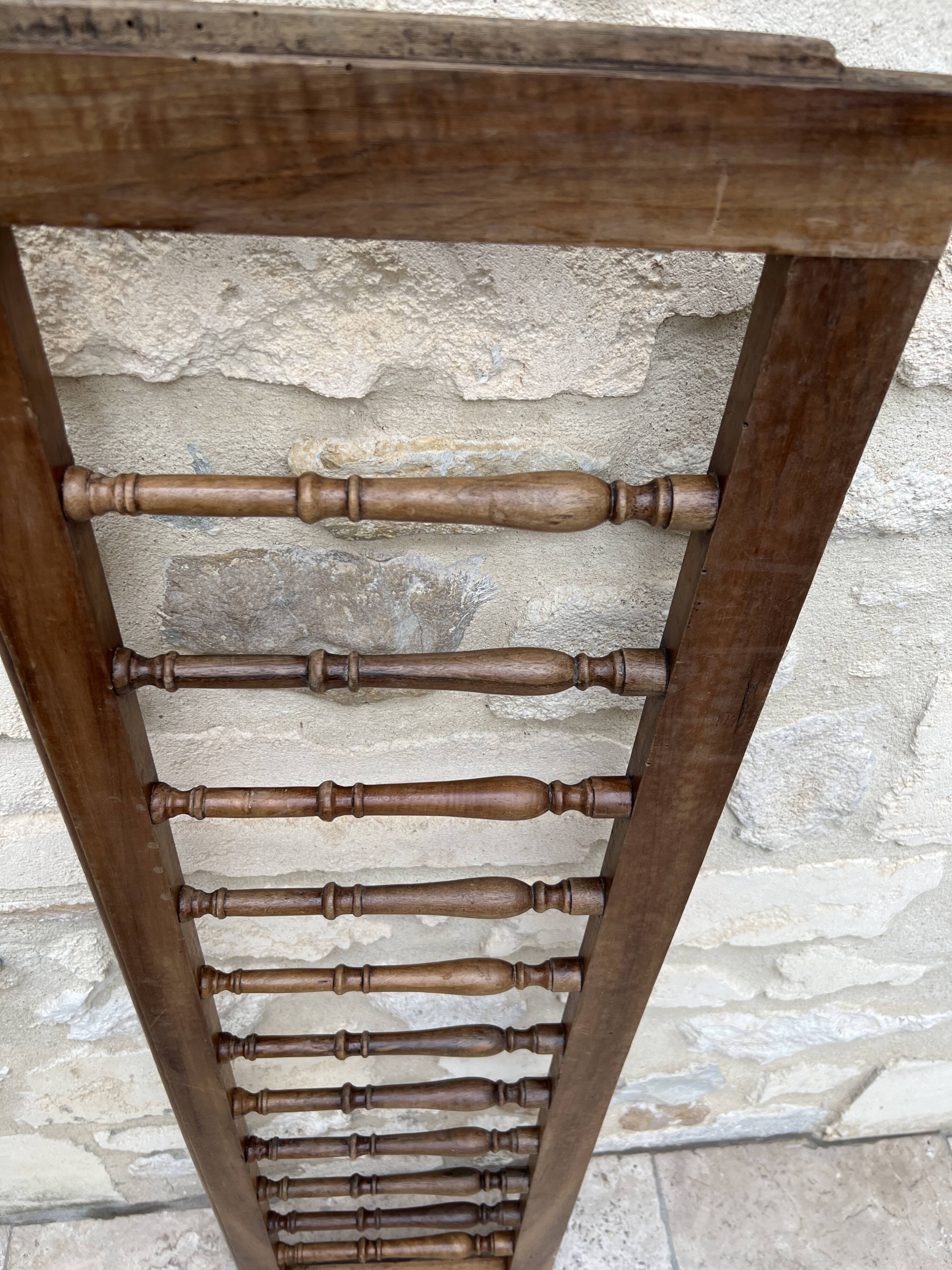 Old children's bed with retractable walnut bars