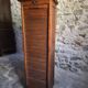 French antique wardrobe with curtain in oak, circa 1920–1930.