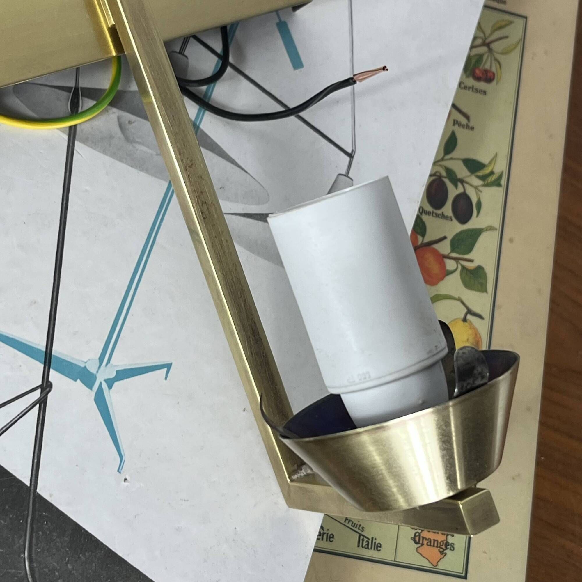 Vintage brass wall light with a white glass spindle shade from the 1950s-1960s.