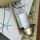 Vintage brass wall light with a white glass spindle shade from the 1950s-1960s.