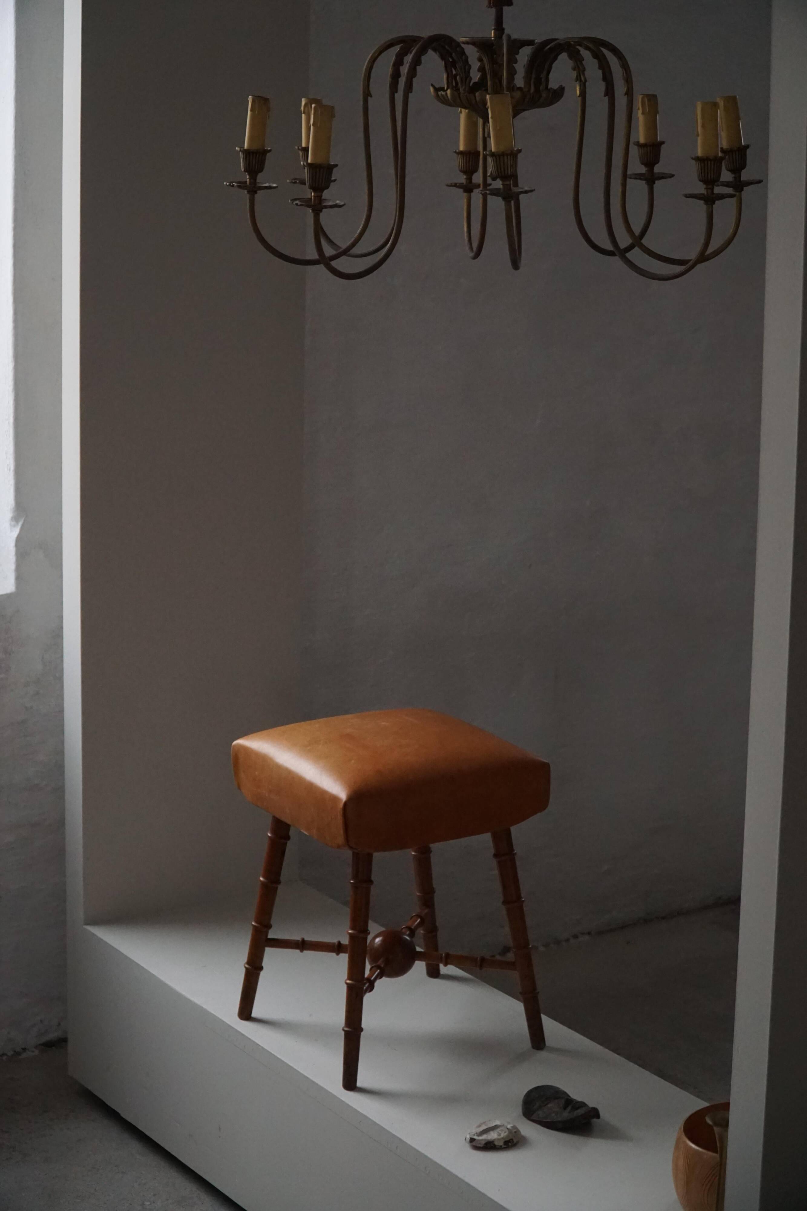 Turned wooden stool with leather seat, mid-20th century, Danish modern.