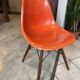 A vintage 70s Eames Herman Miller DSW Fiber Red Orange Dowel Walnut Chair