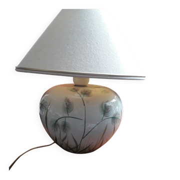 Antique ceramic lamp with a floral design.