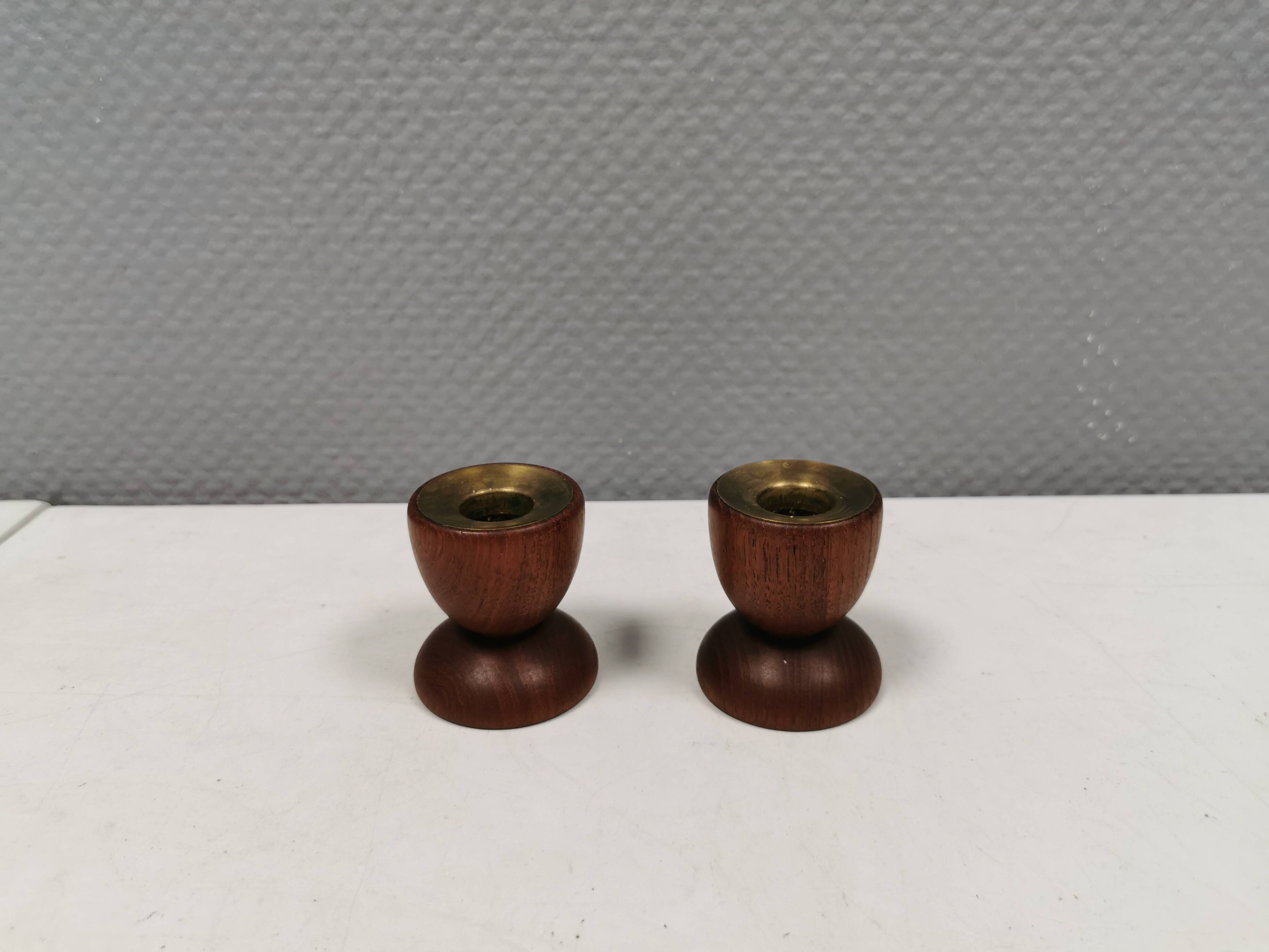 Two beautiful teak candle holders with brass inserts.