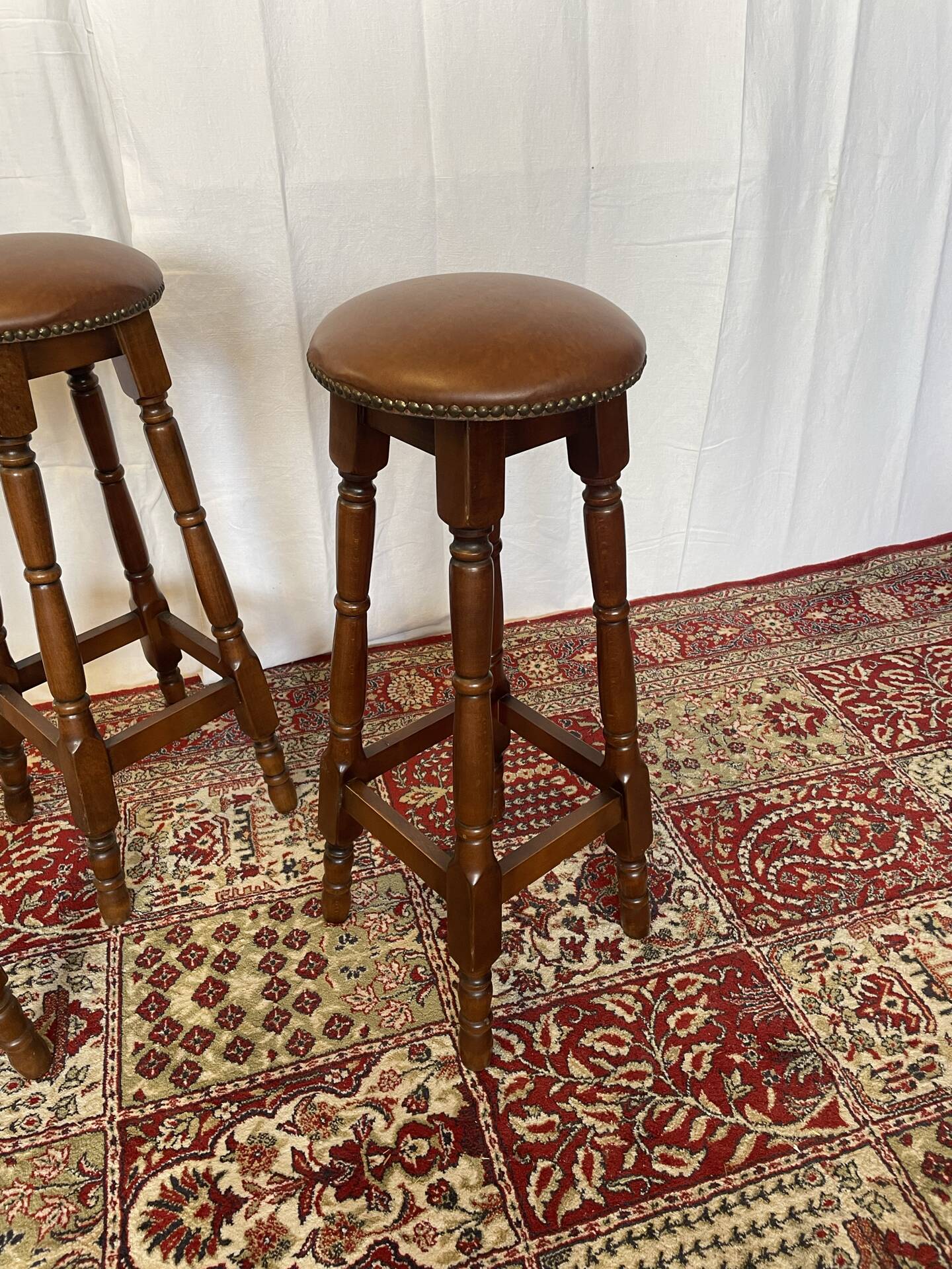 Set of 3 antique wooden and leather bar stools.