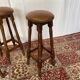 Set of 3 antique wooden and leather bar stools.