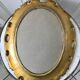 Miroir ovale médaillon en stuc doré années 70