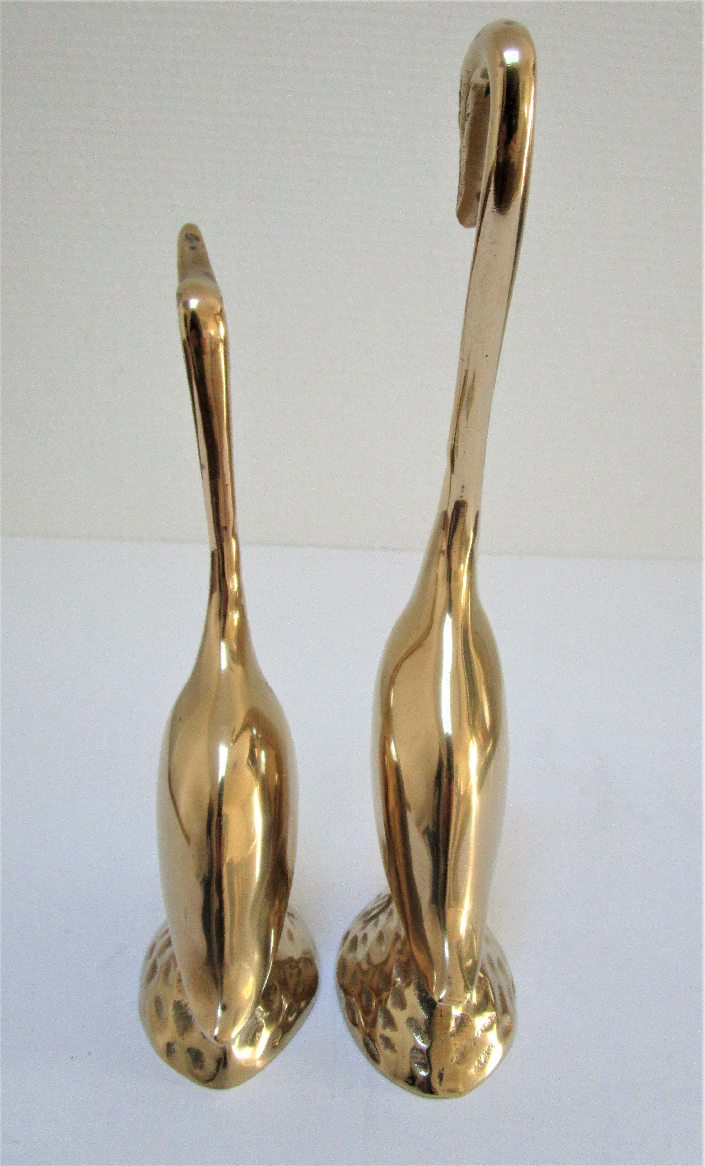 Pair of stylized birds in solid brass