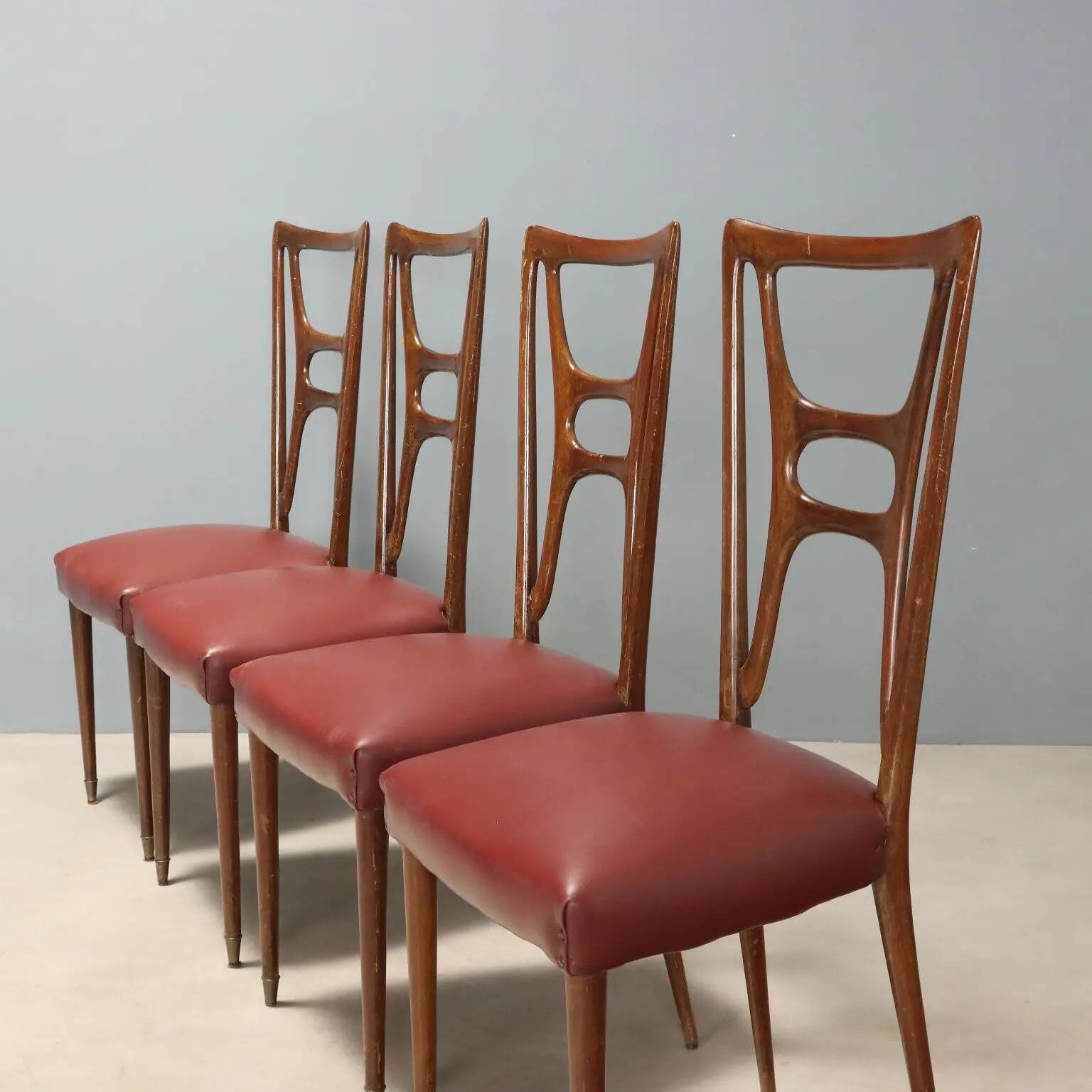 Set of six 1950s chairs with burgundy seats.