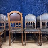 Set of 8 Renaissance style chairs in walnut and embossed leather