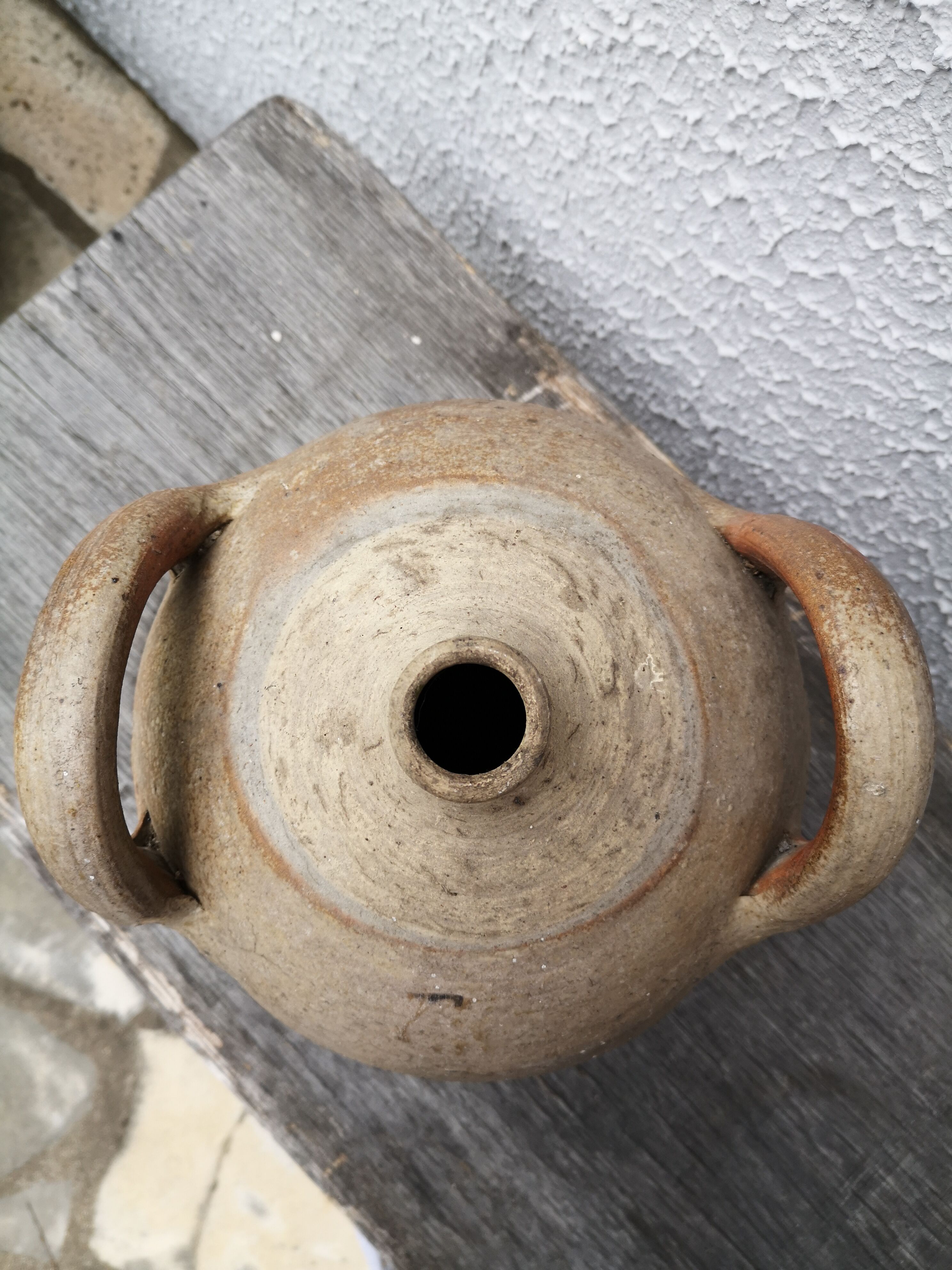 Old terracotta pot with two handles