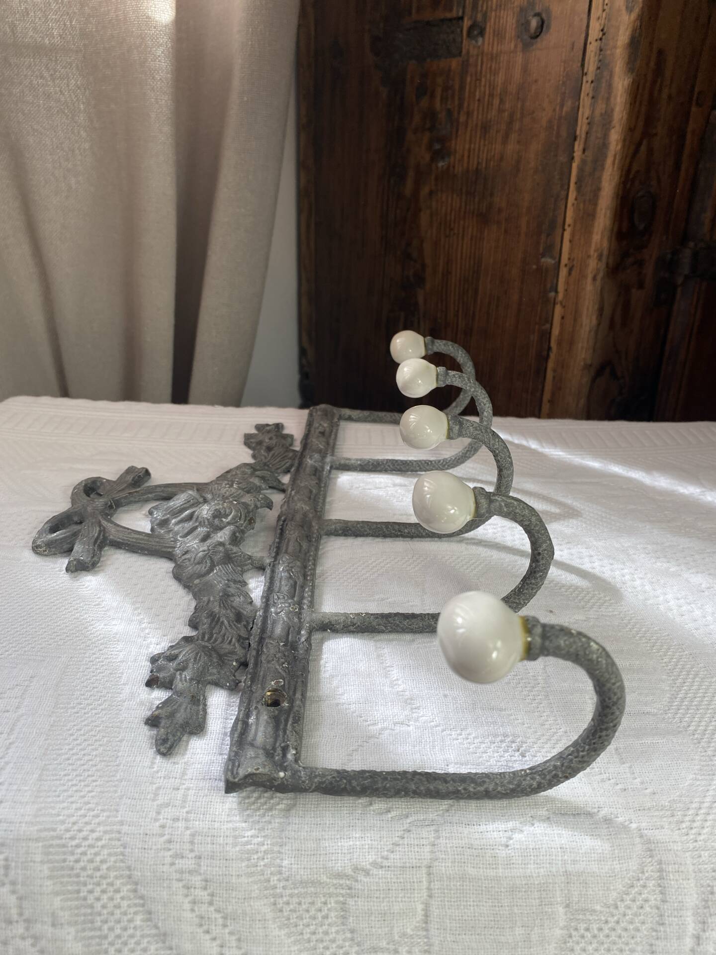 Patinated metal wall bracket and porcelain