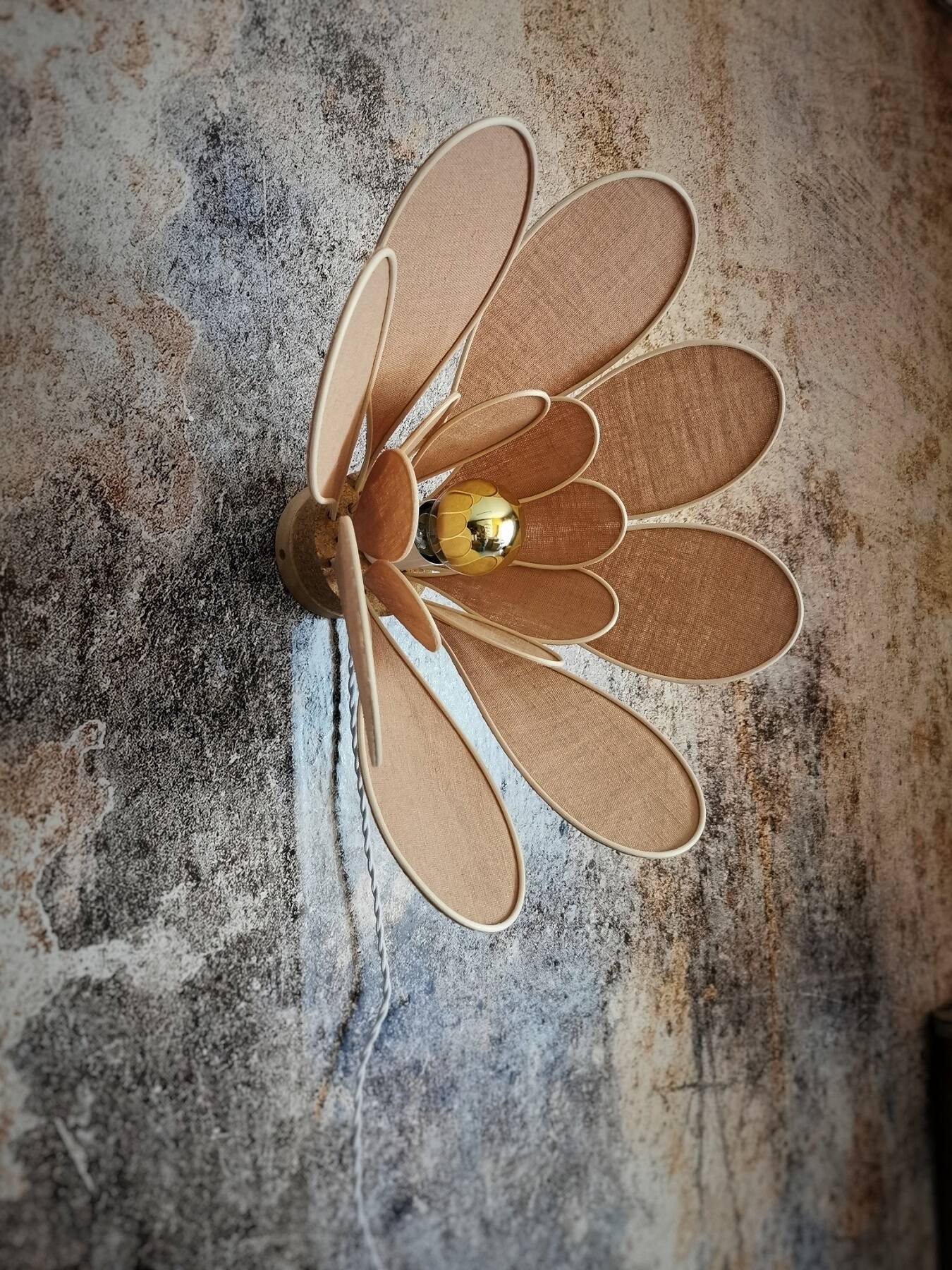 Flower wall light made of rattan and nude linen petals