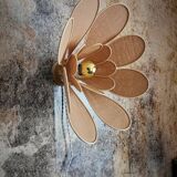 Flower wall light made of rattan and nude linen petals