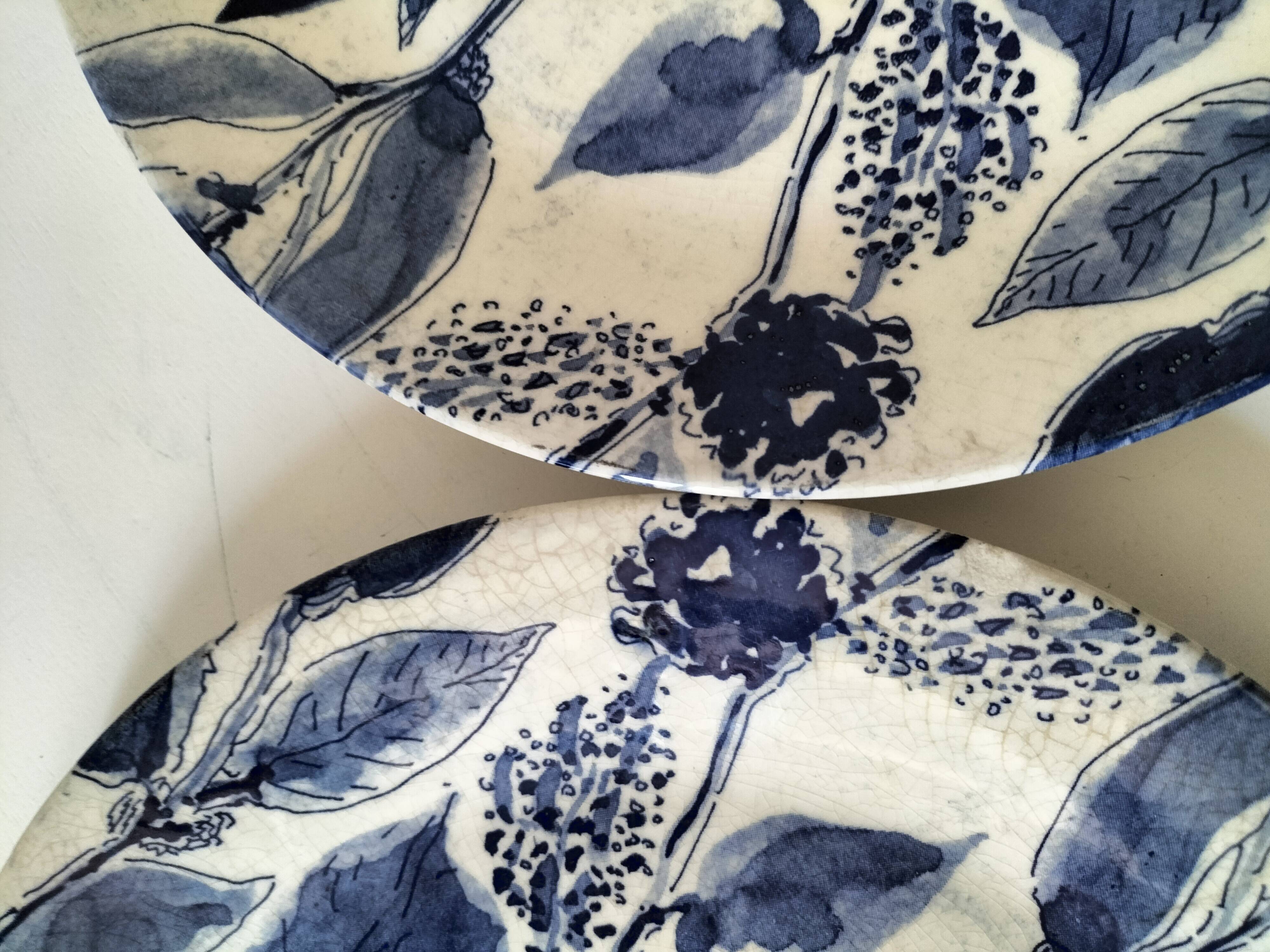 Two flat plates in earthenware with blue floral decoration.