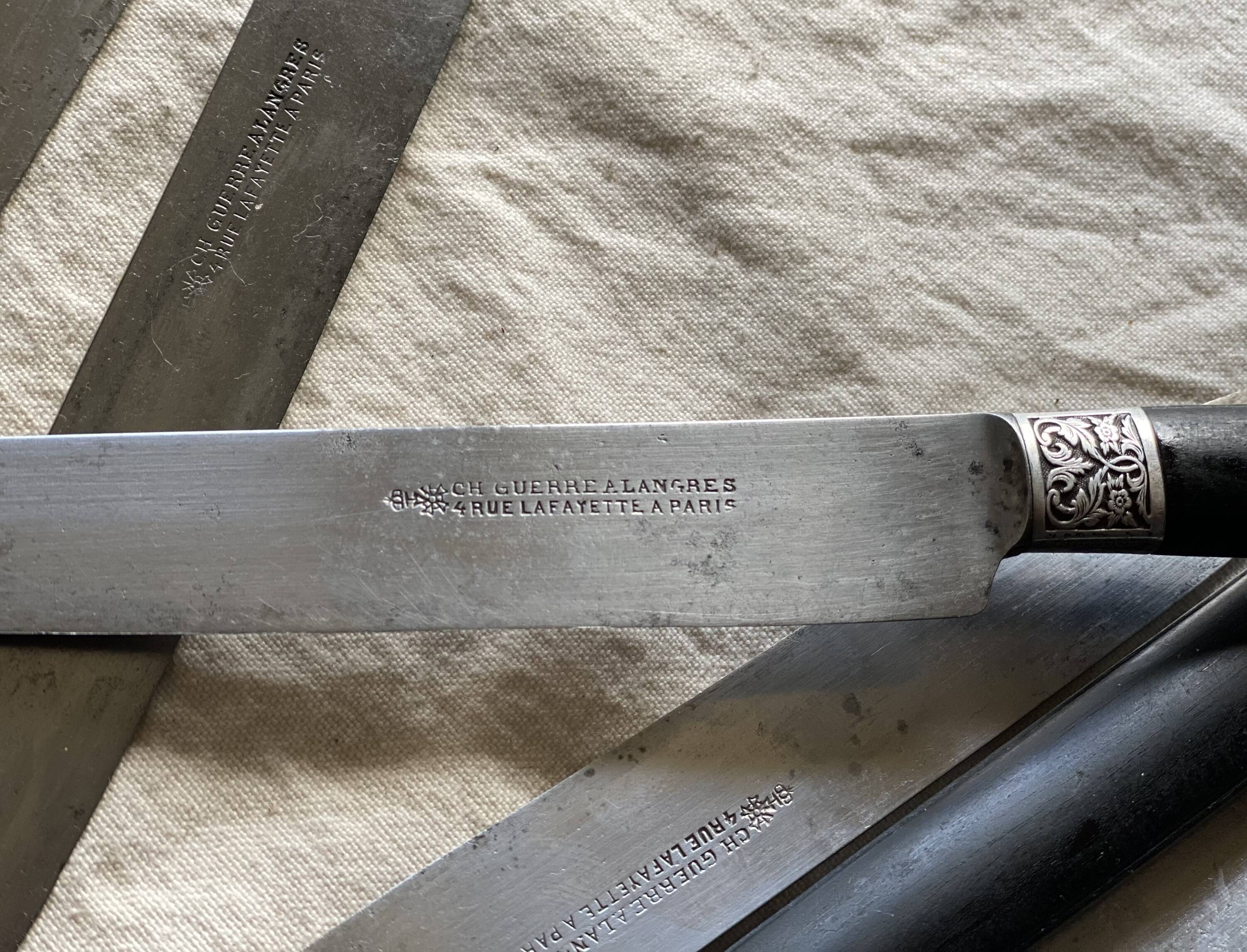 Set of 12 19th century table knives with ebony and chiseled silver handles
