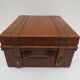 Rectangular wooden suitcase covered with leather