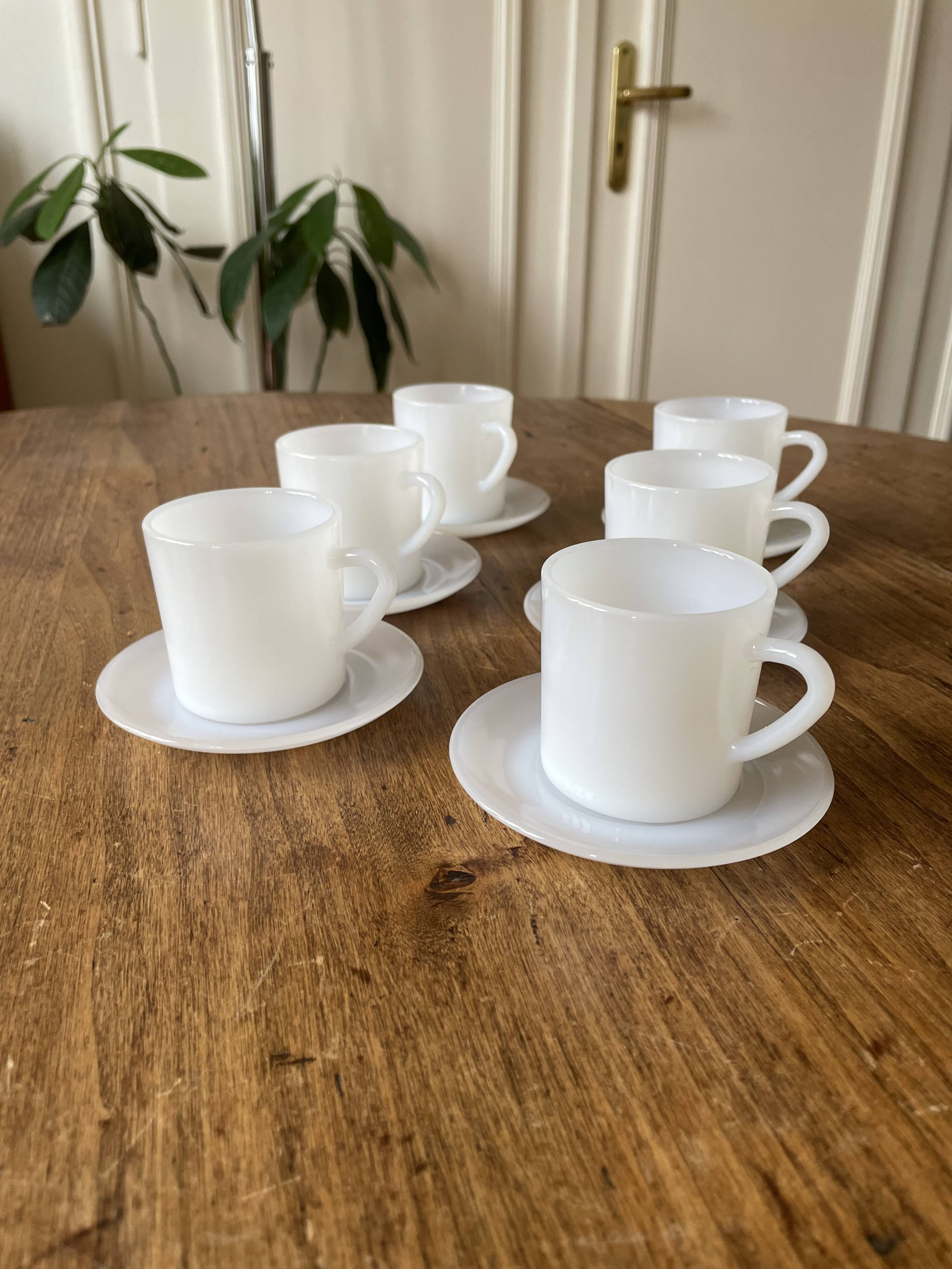 Espresso coffee cup service, Nestlé promotional items, in white glass.
