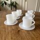 Espresso coffee cup service, Nestlé promotional items, in white glass.