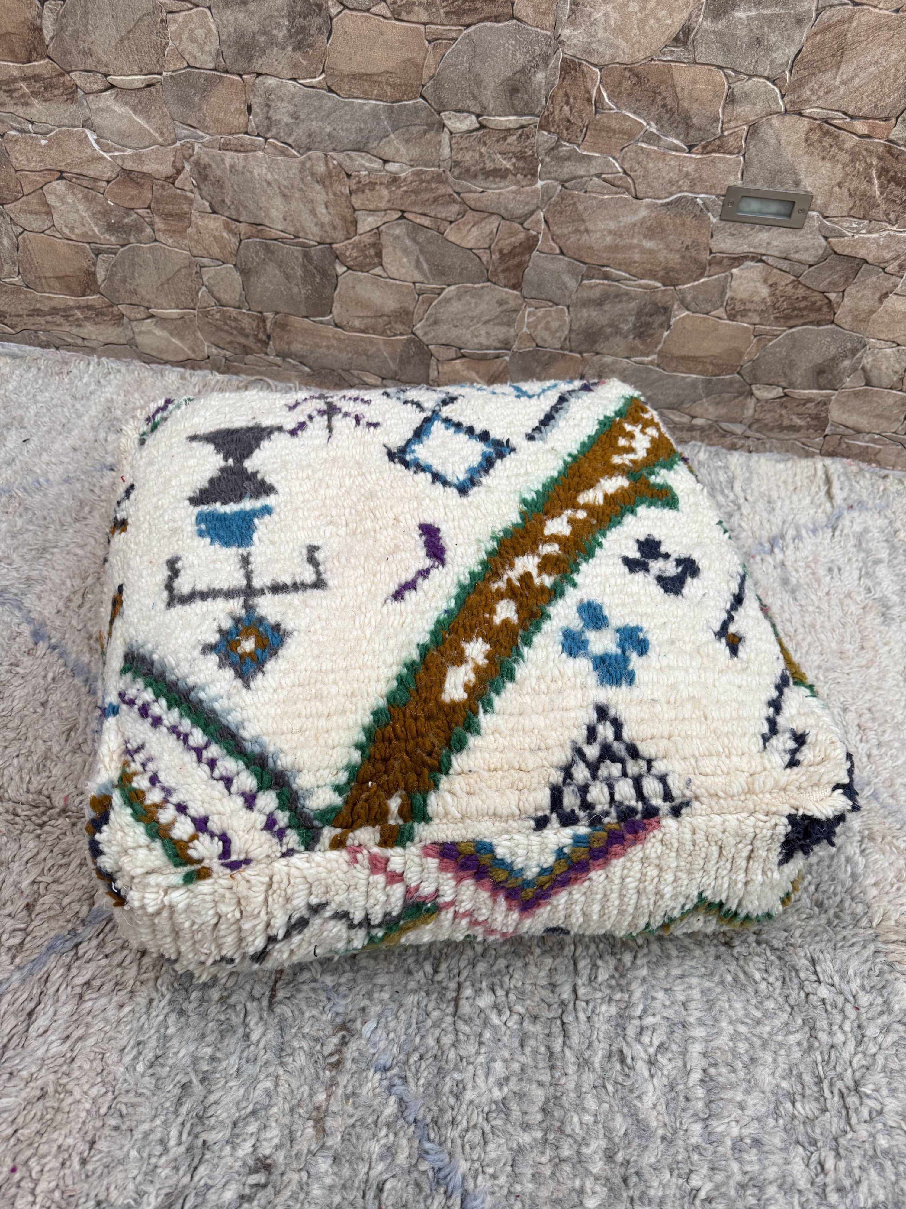 Berber floor pouf: Handwoven Moroccan wool cushion.
