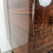 1950s mahogany sideboard with a glass top and central bar.